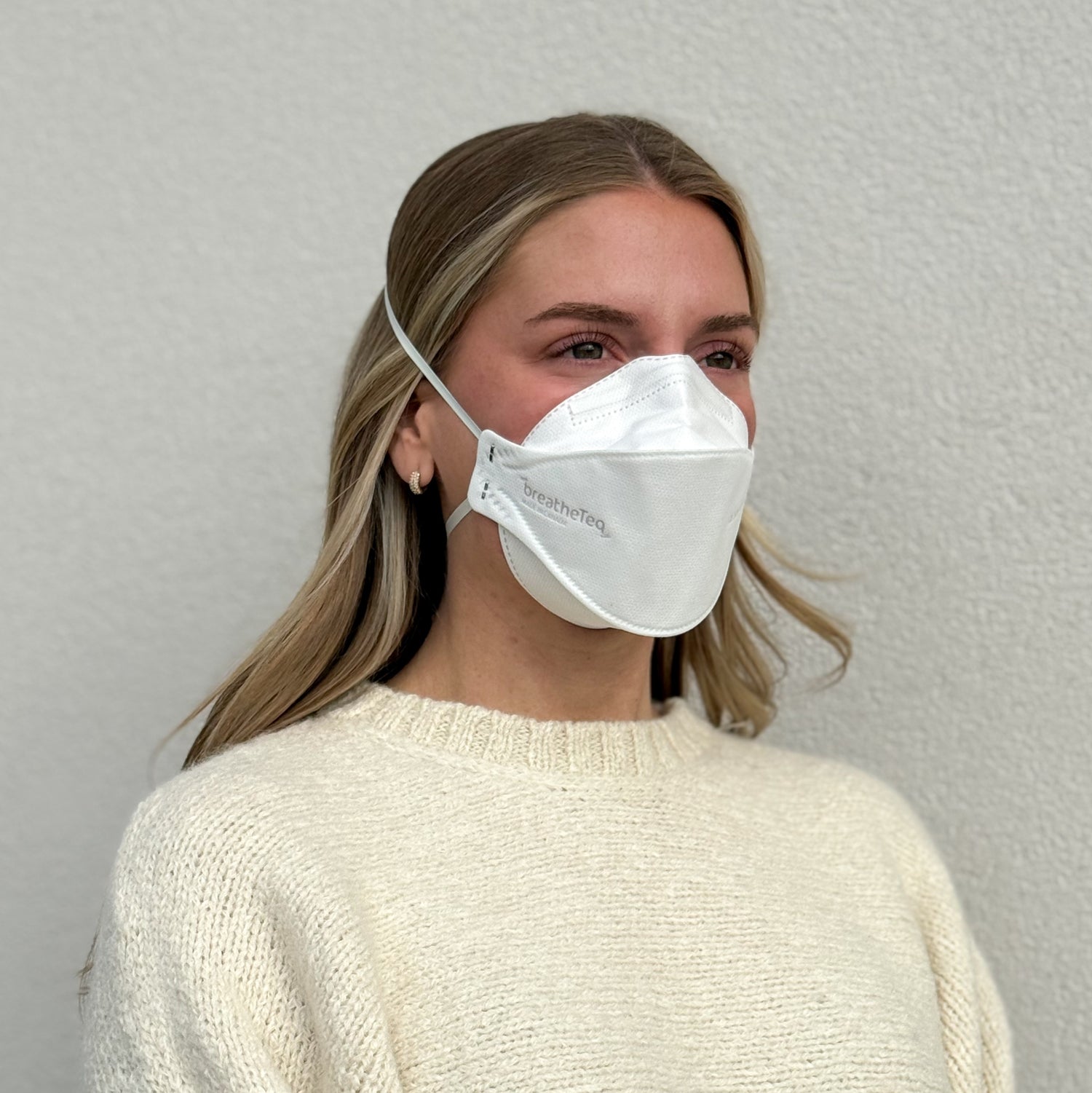 woman wearing white KN95 mask with headbands breathable made by Breatheteq USA in Canada