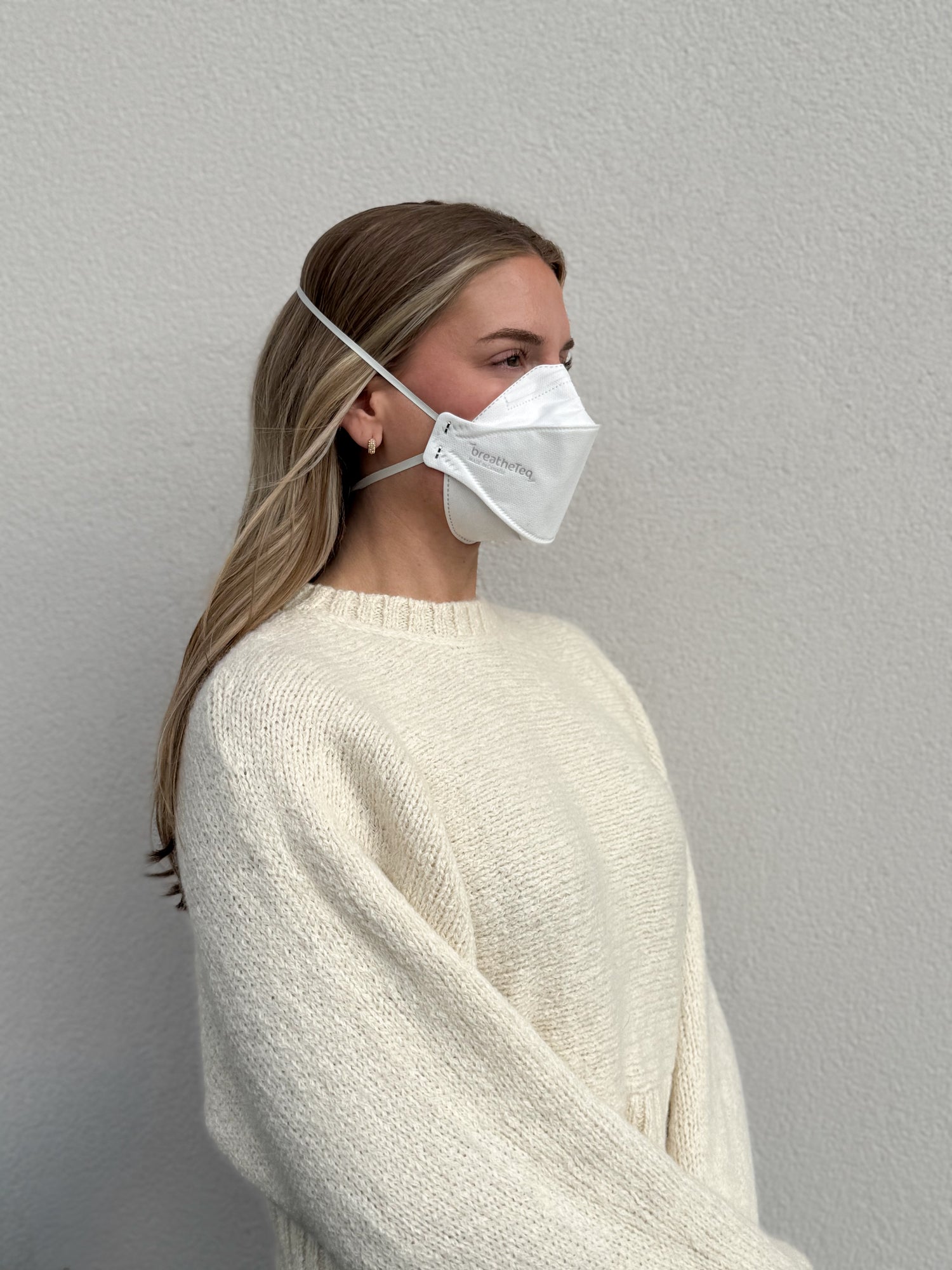 woman facing right wearing white KN95 breathable headband mask - not NIOSH N95