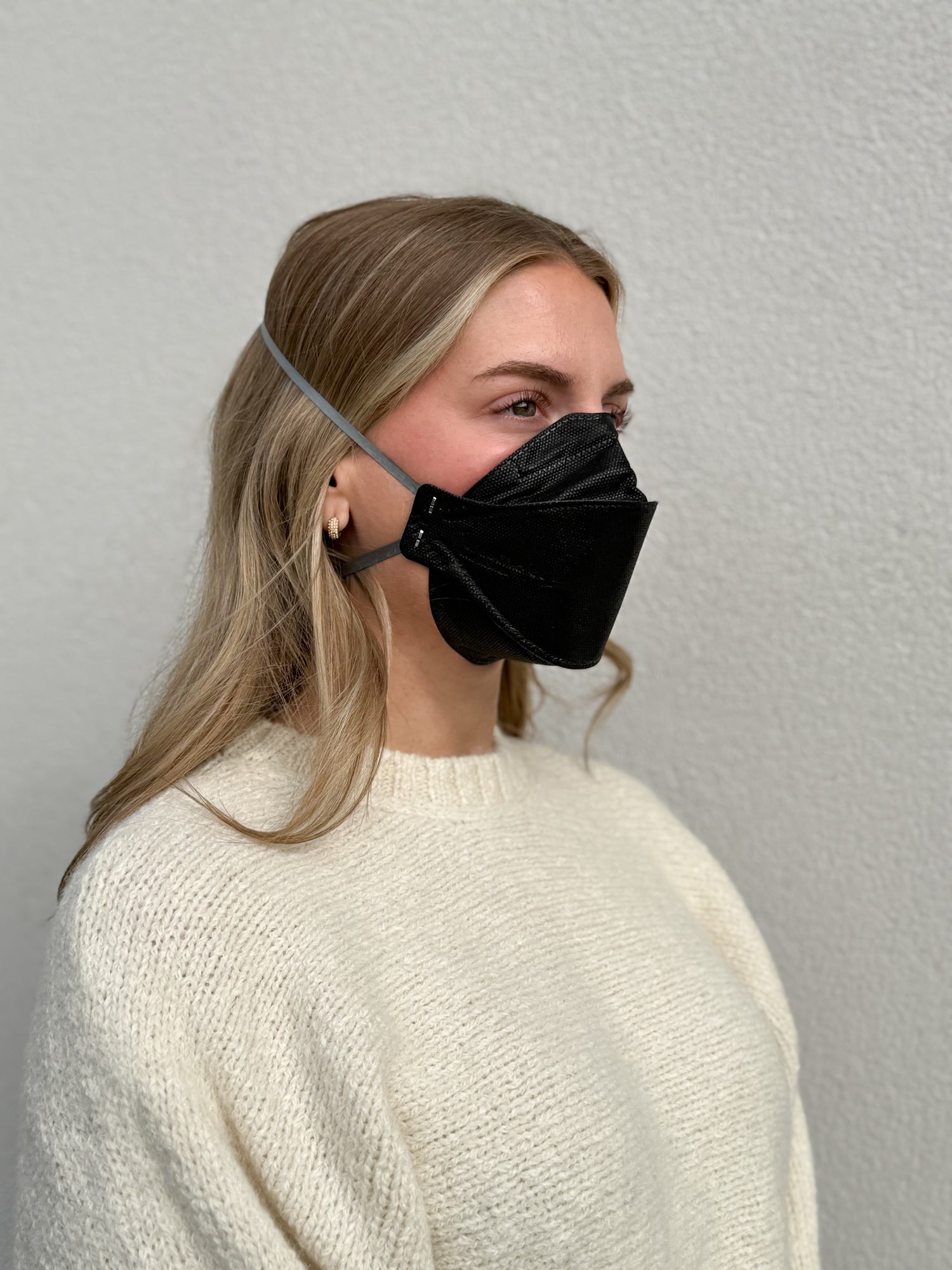 Woman with black aura wearing black KN95 earloop respirator face mask breatheTeq USA made in Canada