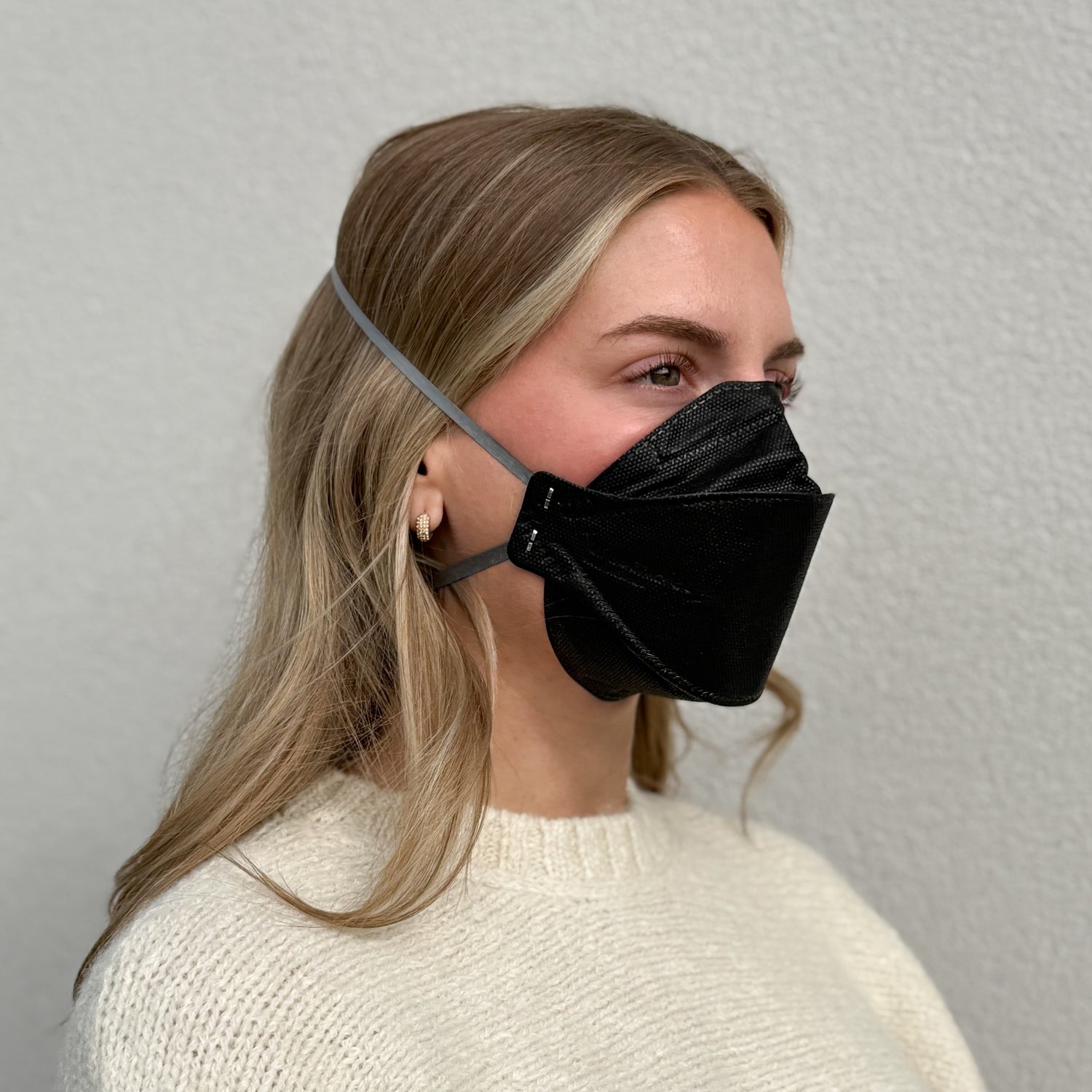 Woman with black aura wearing black KN95 earloop respirator face mask breatheTeq USA made in Canada