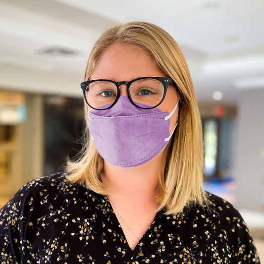 Woman wearing purple lavender KN95 earloop respirator face mask breatheTeq USA made in Canada