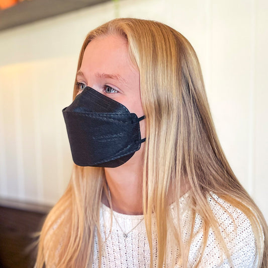 Small woman teen wearing black breatheTeq KN95 face mask made in Canada ships to USA