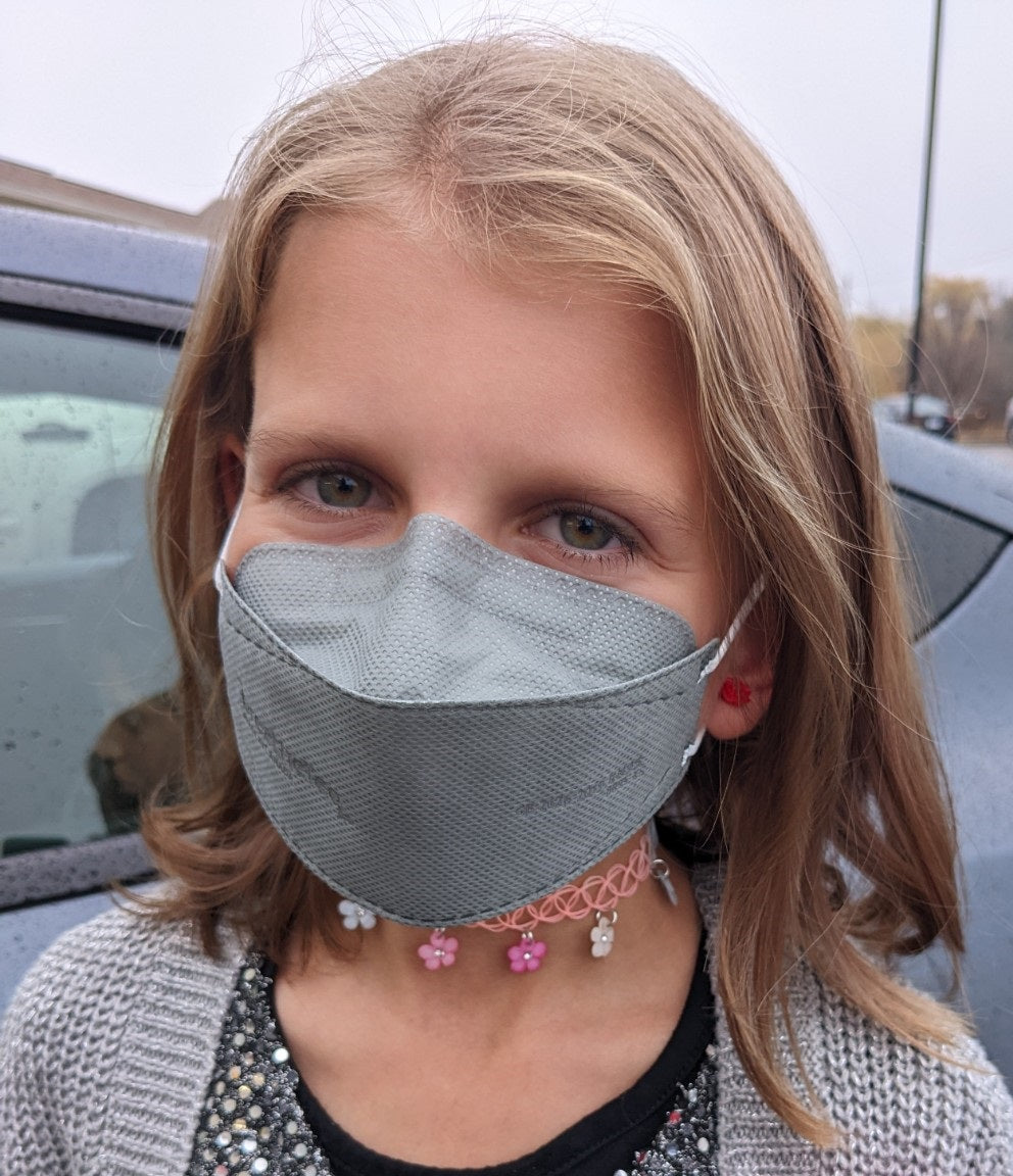 Girl wearing kids XS extra small gray breatheTeq KN95 face mask in USA