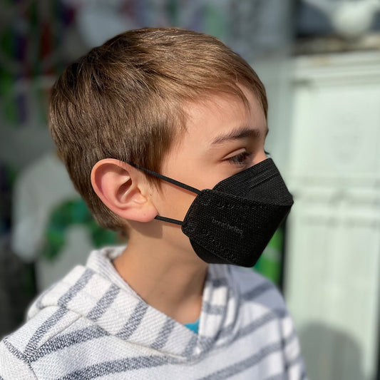 Child wearing kids XS extra small black breatheteq KN95 respirator face mask with earloops