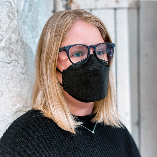 Woman with glasses wearing black KN95 KF94 fish style face mask respirator breatheTeq made in Canada