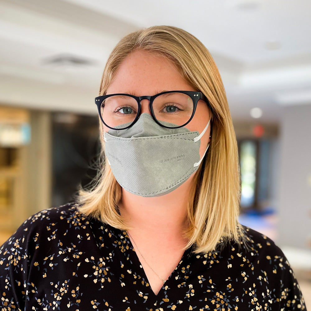 Woman wearing gray breatheTeq KN95 face mask glasses prevent fogging