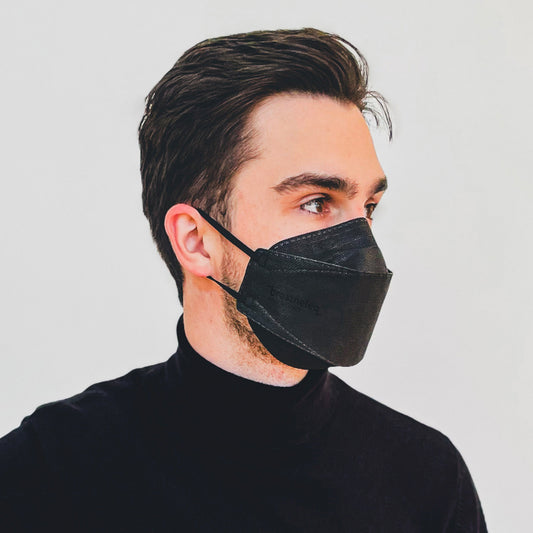 Man wearing black breatheTeq KN95 earloop respirator mask made in Canada